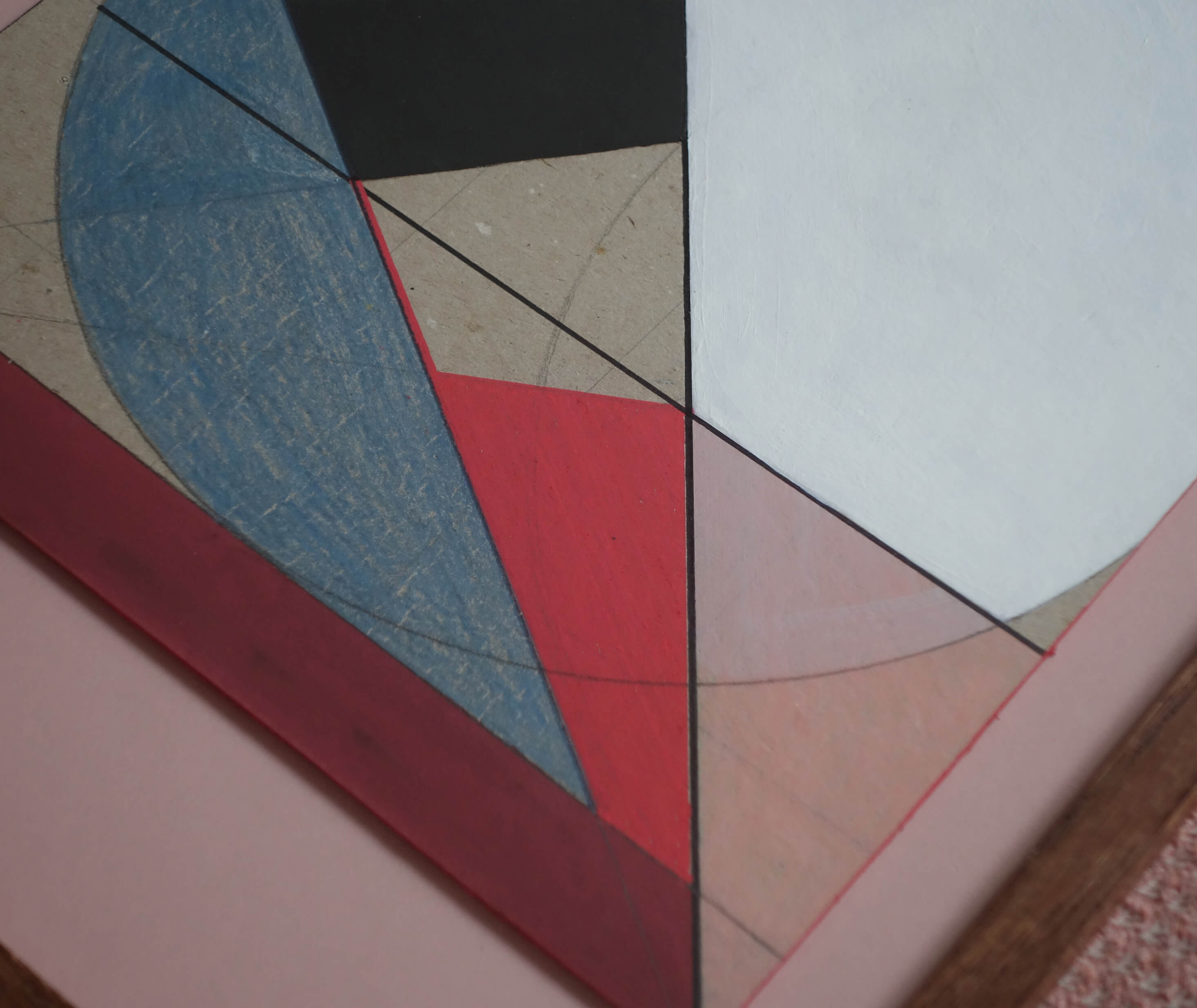 Close-up of hand-drawn geometric lines on cardboard relief