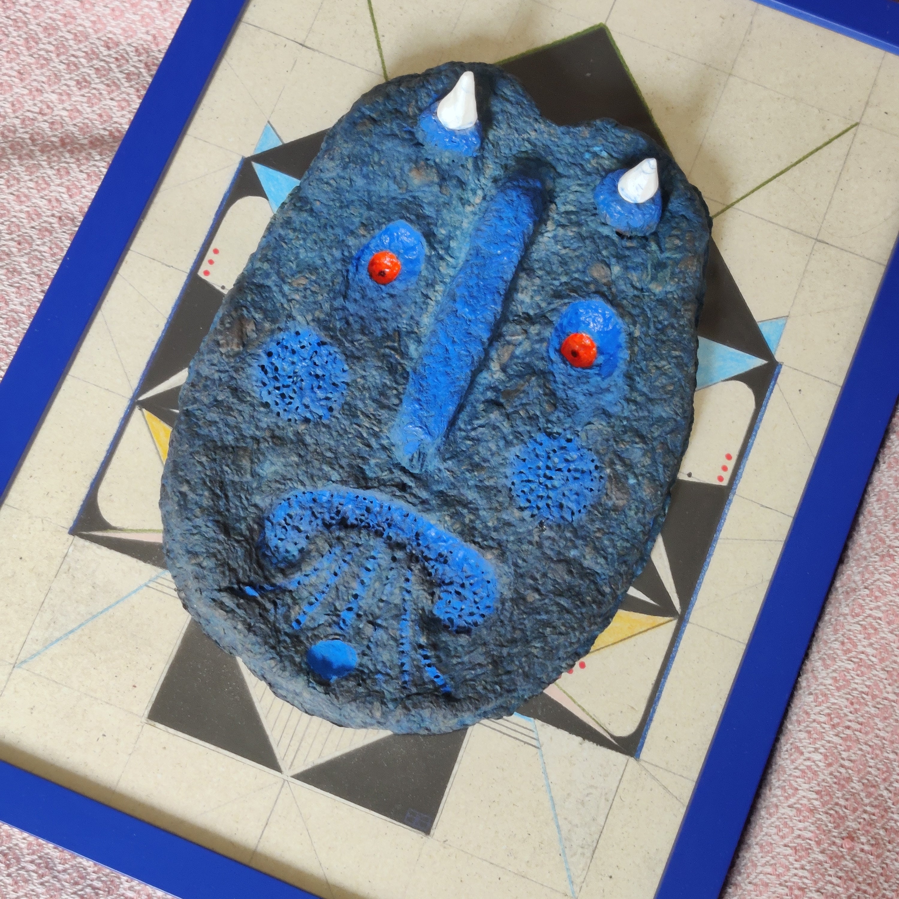 Close-up of A Blue Devil showing layered cardboard and paint