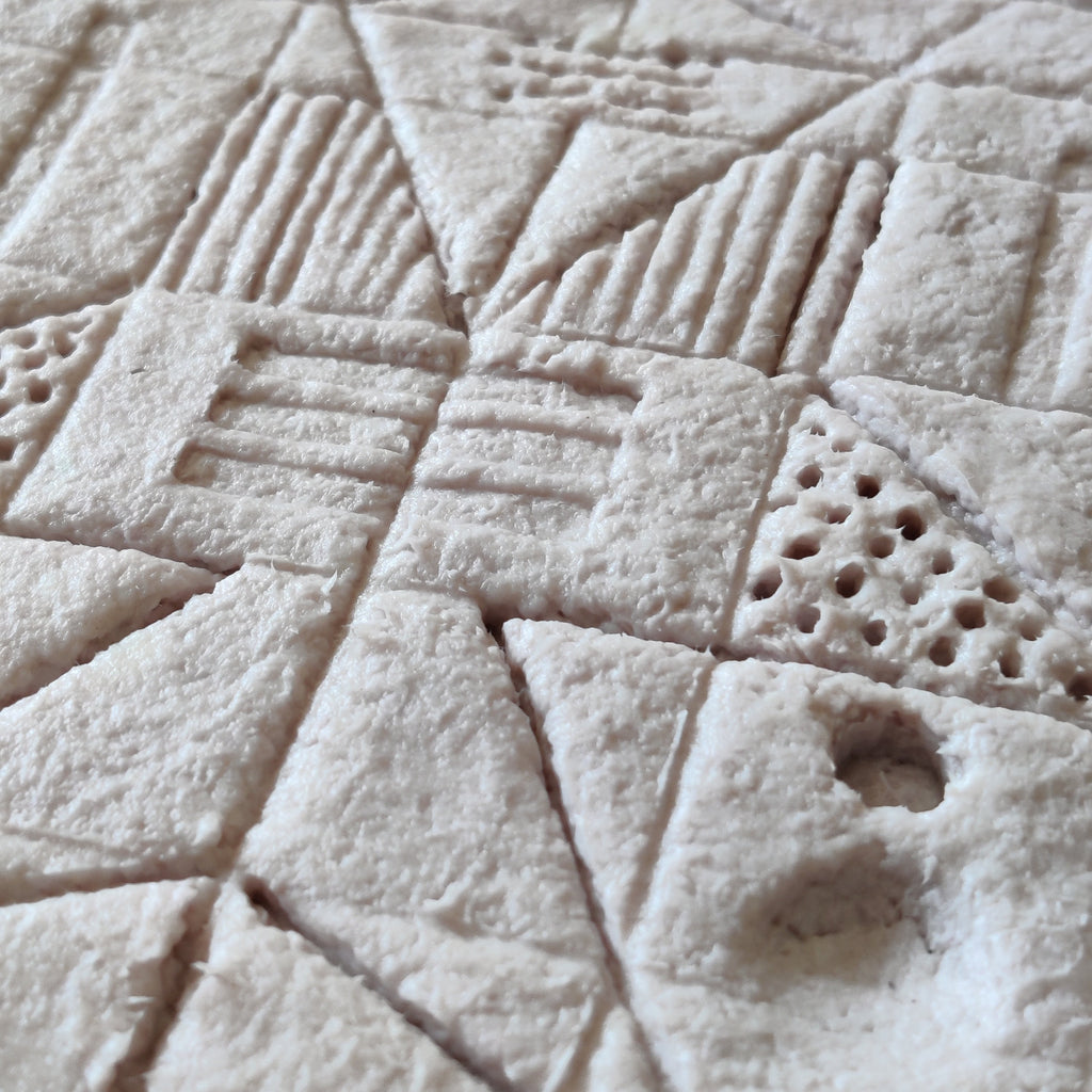 Ancient-inspired wall art closeup wet paper pulp clay before drying