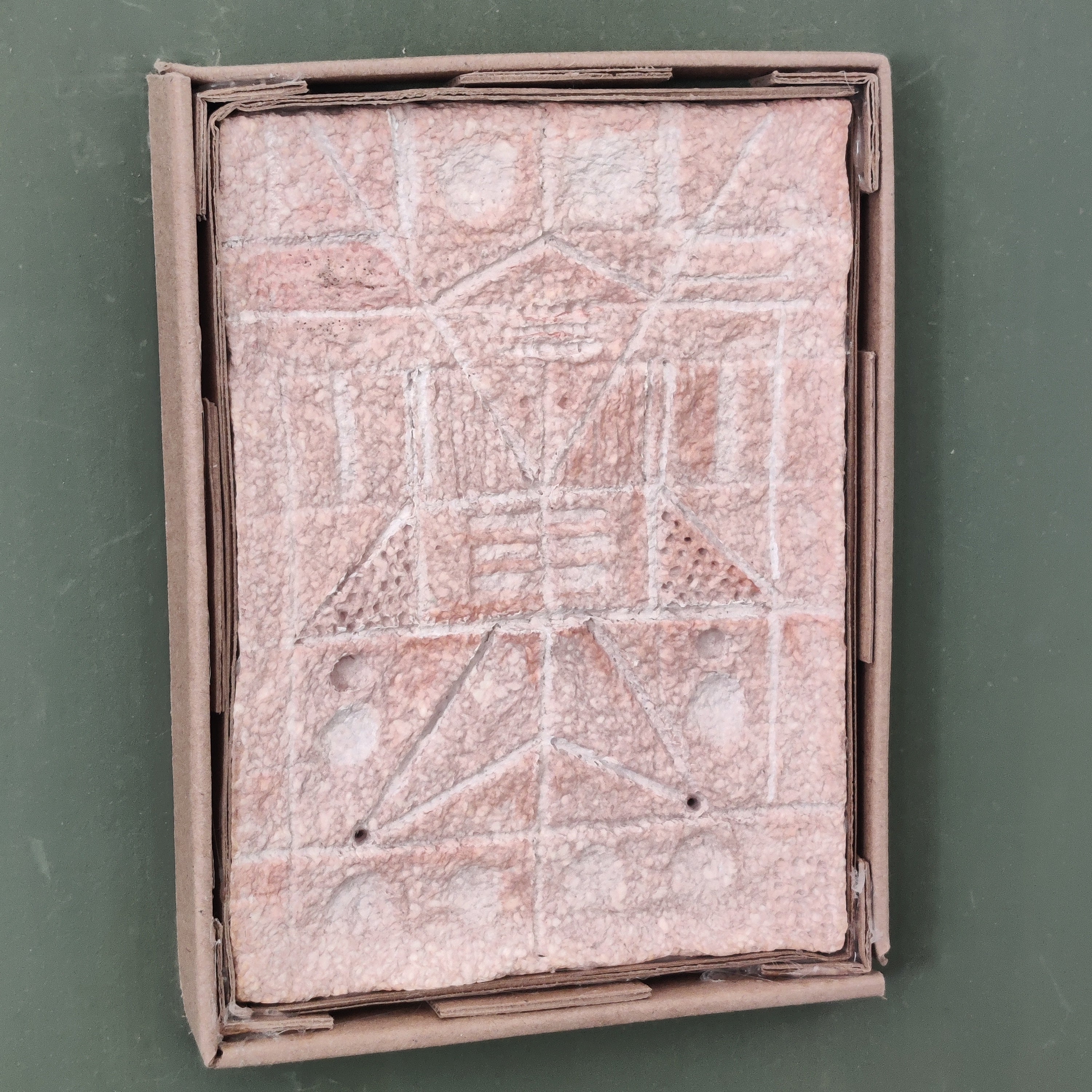 Handmade paper clay relief sculpture showing texture detail and cardboard frame