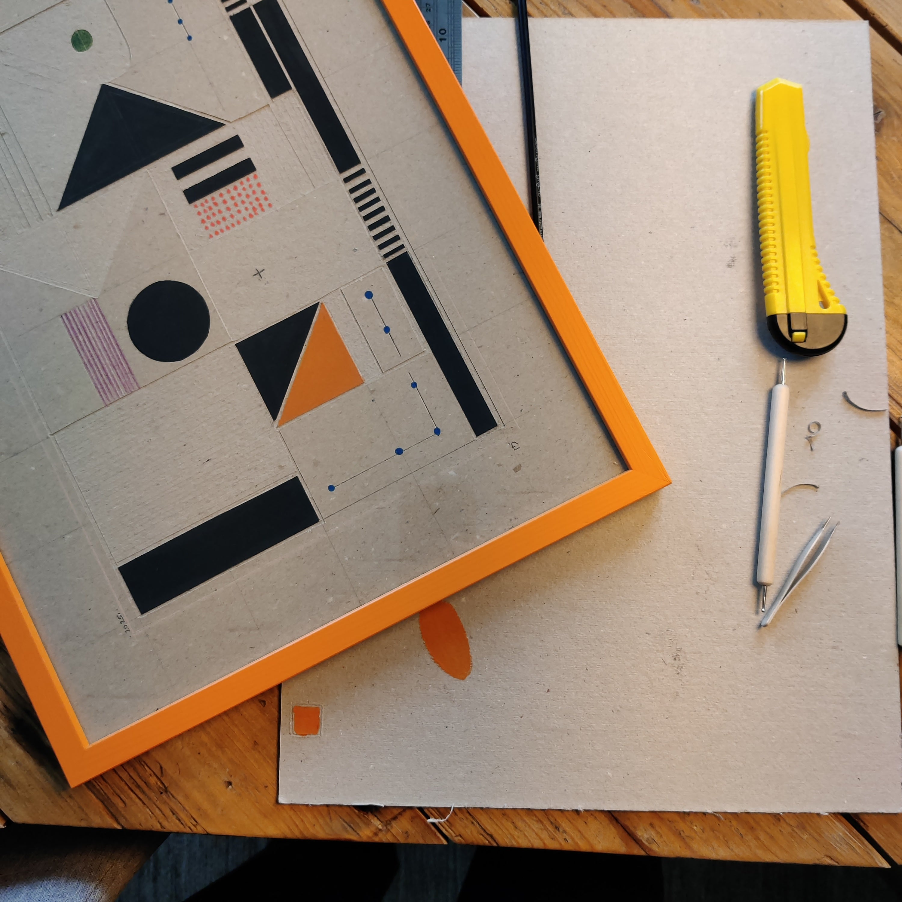 Handmade cardboard sculpture with bold color blocking - red orange blue yellow