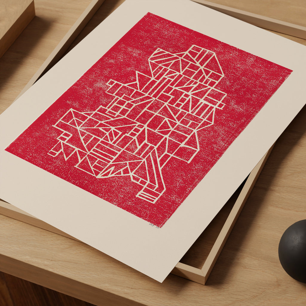 A matted art print featuring an abstract geometric line drawing in white on a textured red background, displayed on a light wooden surface.