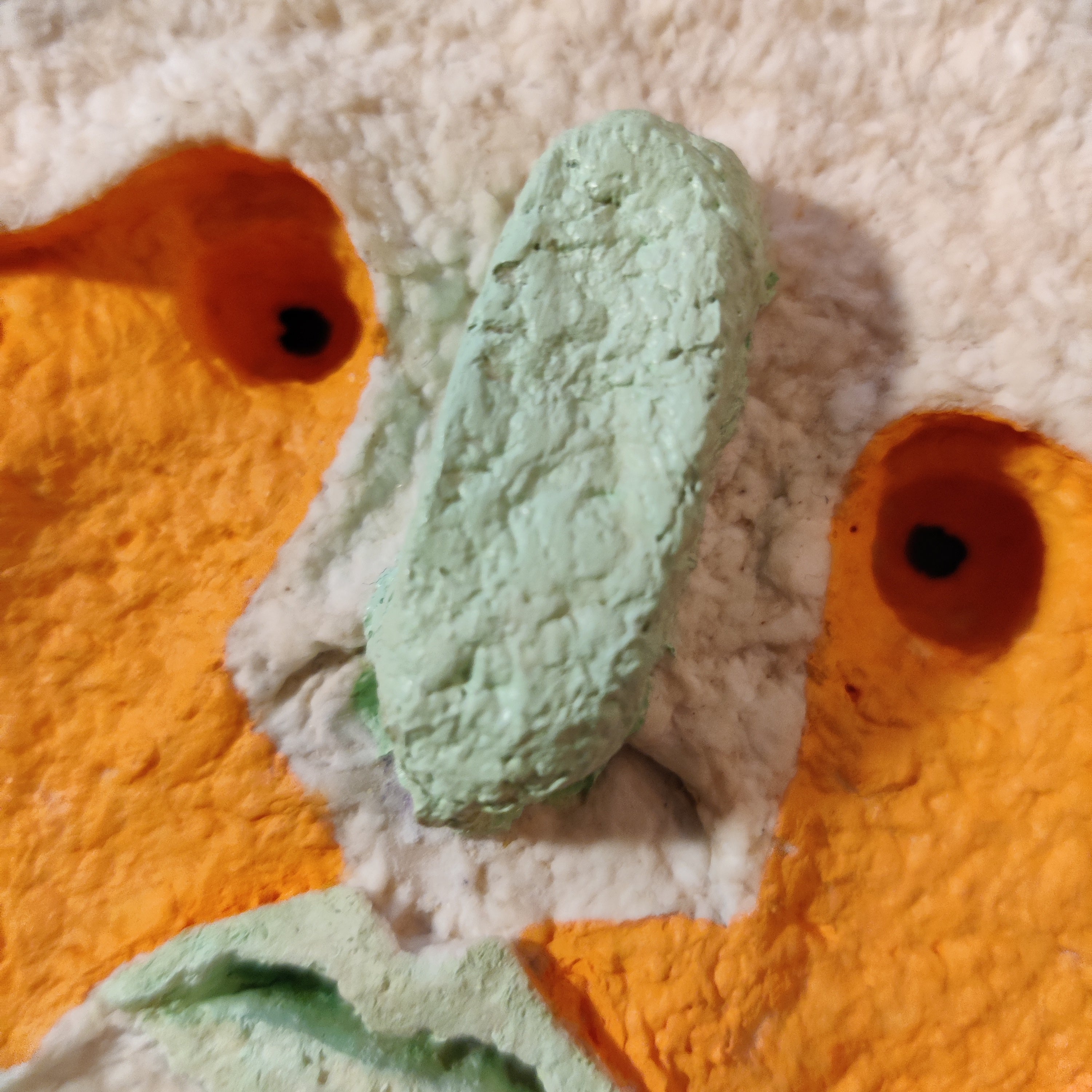 Close-up of a textured surface. Sun king artwork by Lisa Ketty.