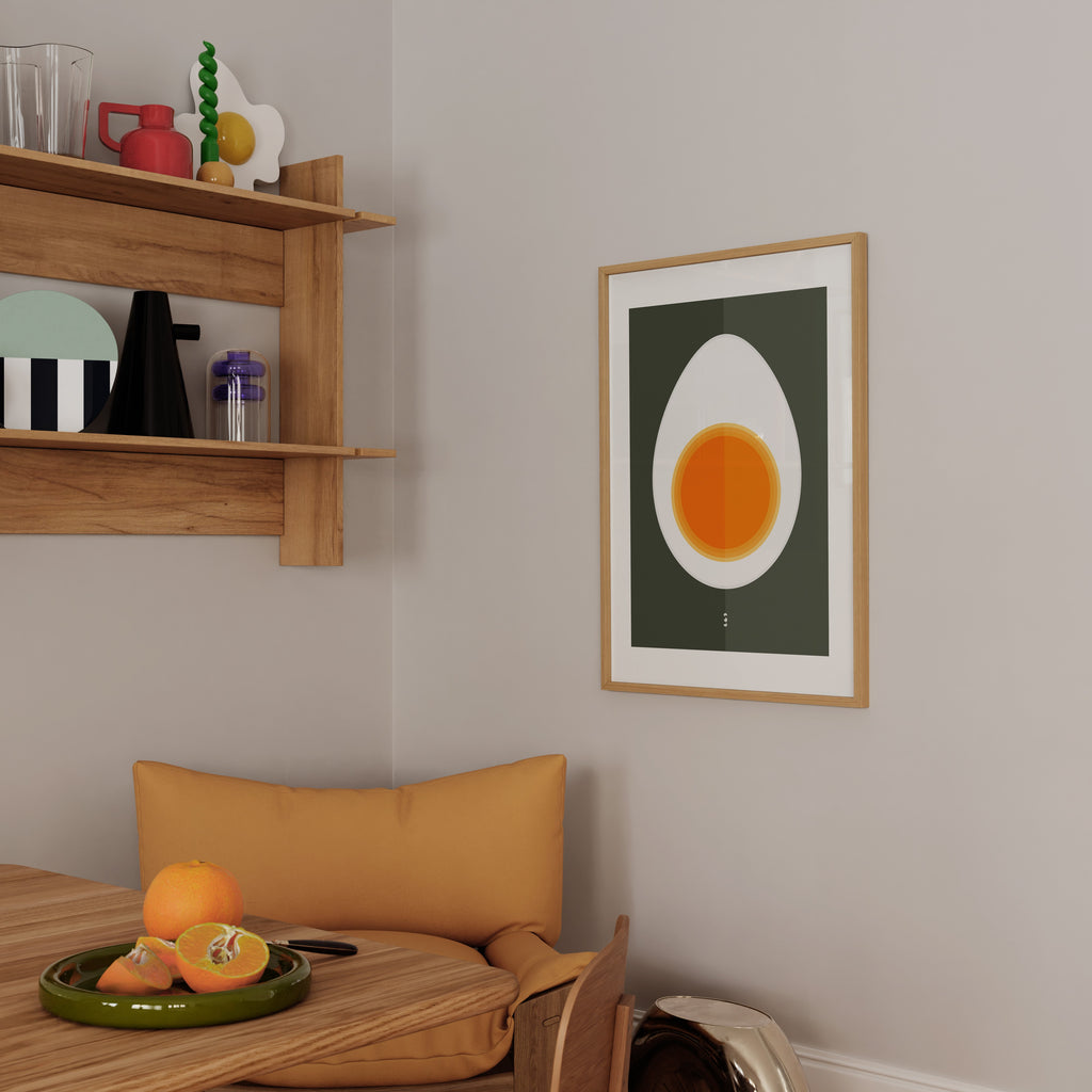 Half Egg Poster by Lisa Ketty in a light wood frame on a kitchen wall