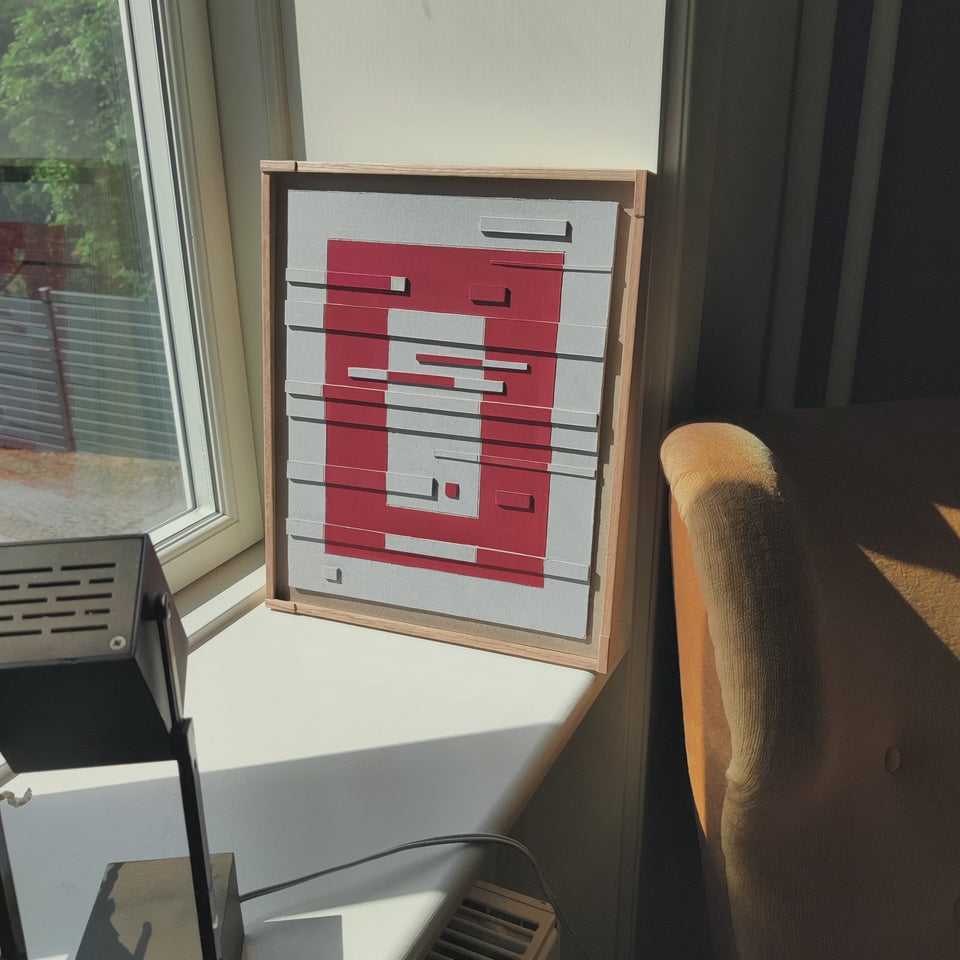 man takes the artwork and hang in on the wall 